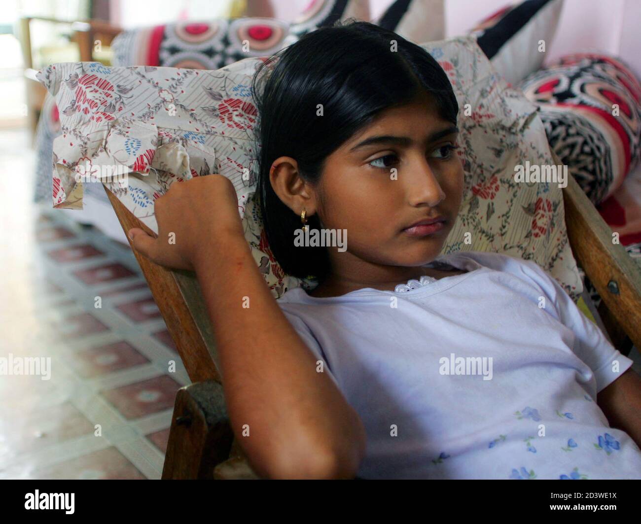 Almas, a twelve-year-old Indian girl, rests at her relatives' house in Port  Blair January 5, 2005 after she was rescued by soldiers on Monday on the  remote Indian island of Nacowrie in