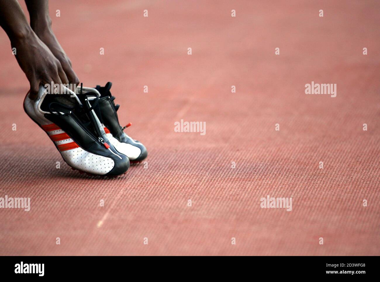France's Sylvanie Morandais takes her training shoes after the women's 400  metres hurdles final at the XV Mediterranean Games Almeria 2005 in Almeria,  southern Spain, June 30, 2005. [Morandais finished in sixth