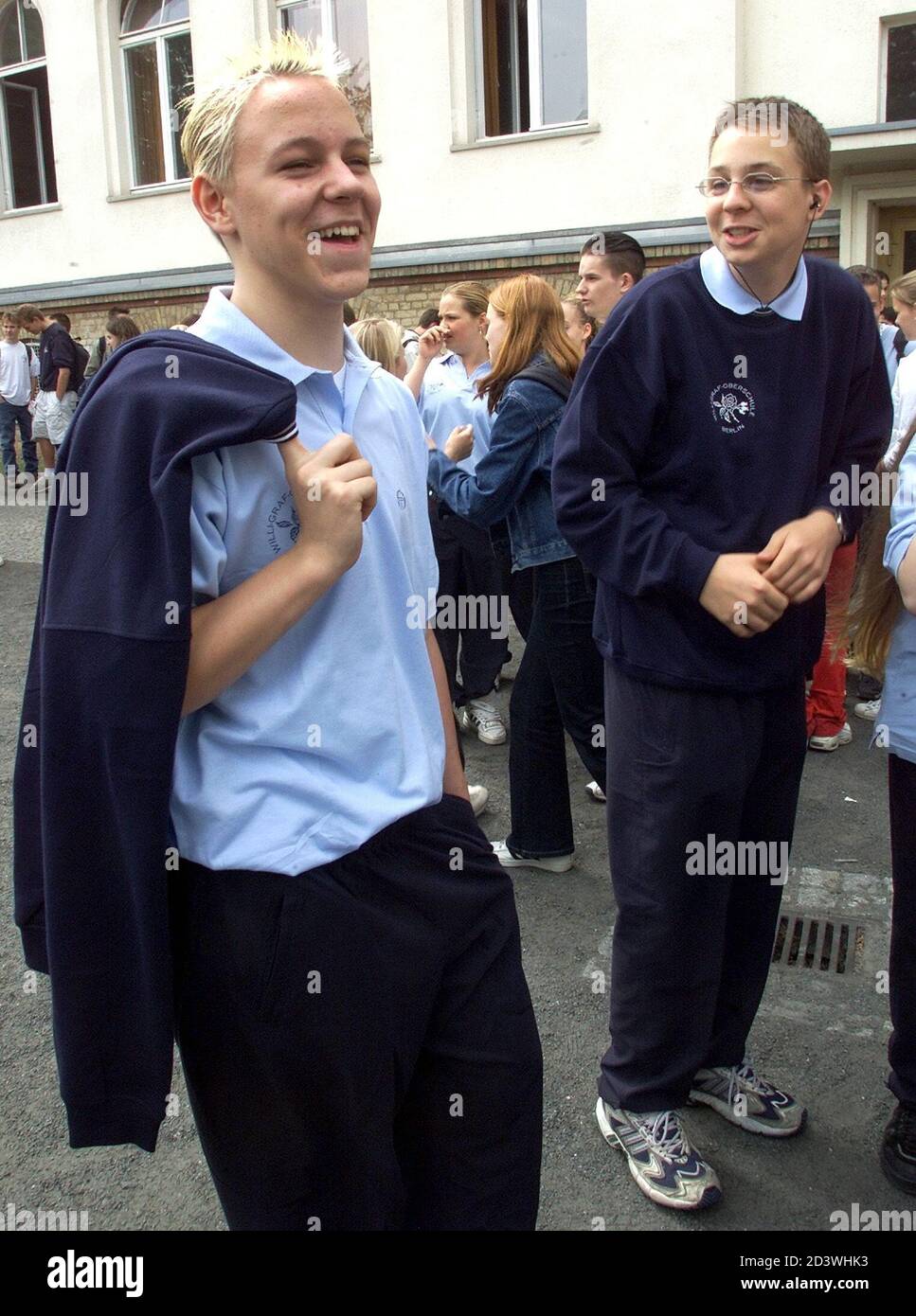 14-year-old Andy Benn (L) jokes around with a class mate, as they wear their brand new school uniform, which is being piloted at the Willi-Graf-Oberschule in Berlin May 21, 2001. The uniform trial starts today in two classes of this school and runs until the beginning of the summer holidays. Pupils at German state schools do not wear uniforms.  AX/JOH Stock Photo