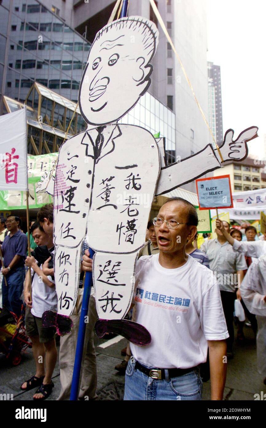 A protester carries an effigy of Hong Kong Chief Executive Tung Chee-hwa as he and more than 800 other protesters demanded direct elections of the territory's leader, during a demonstration in Hong Kong, July 1, 2001. The territory celebrates the fourth anniversary of its reunion with China, but various protests were held as spirits have been dampened by rising unemployment, falling incomes, and fears that promises of autonomy from communist rule have been eroded. Chinese characters on the effigy read 'I will be chosen for the second term.  BY/RCS Stock Photo