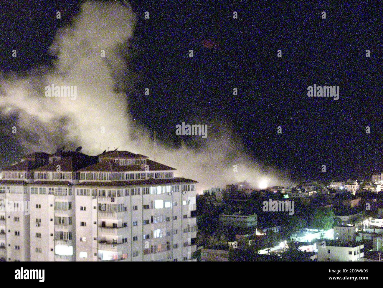 Smoke rises over Palestinian police headquarters after it was hit by missiles from Israeli warplanes in the Gaza Strip December 14, 2001. Israeli F-16 fighter planes dropped at least two bombs on a Palestinian security target in Gaza City on Friday, in the latest retaliatory military strike for a wave of Palestinian attacks. REUTERS/Suhaib Salem SJS/CLH/ Stock Photo