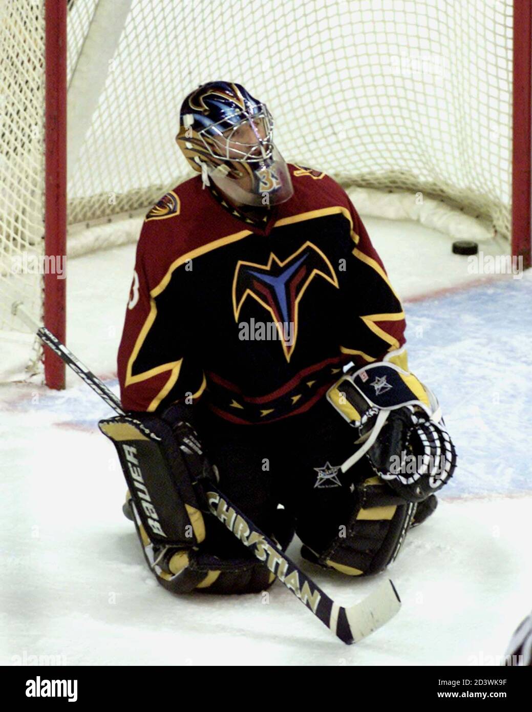 Atlanta Thrashers goalie Milan Hnilicka kneels dejected as the puck, shot  by Washington Capitals' Joe Reekie, sits in the goal, during the first  period of their game at the MCI Center in