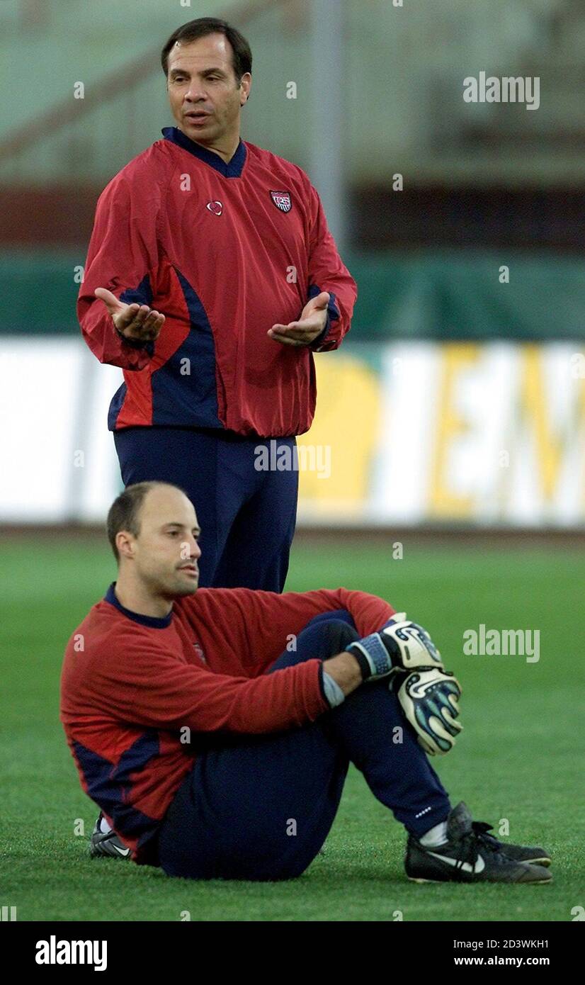 U.S. coach Bruce Arena gestures as goalkeeper Kasey Keller looks on at the  Cibali Stadium in the southern Italian Sicilian town of Catania during U.S.  soccer team practice February 12, 2002. The