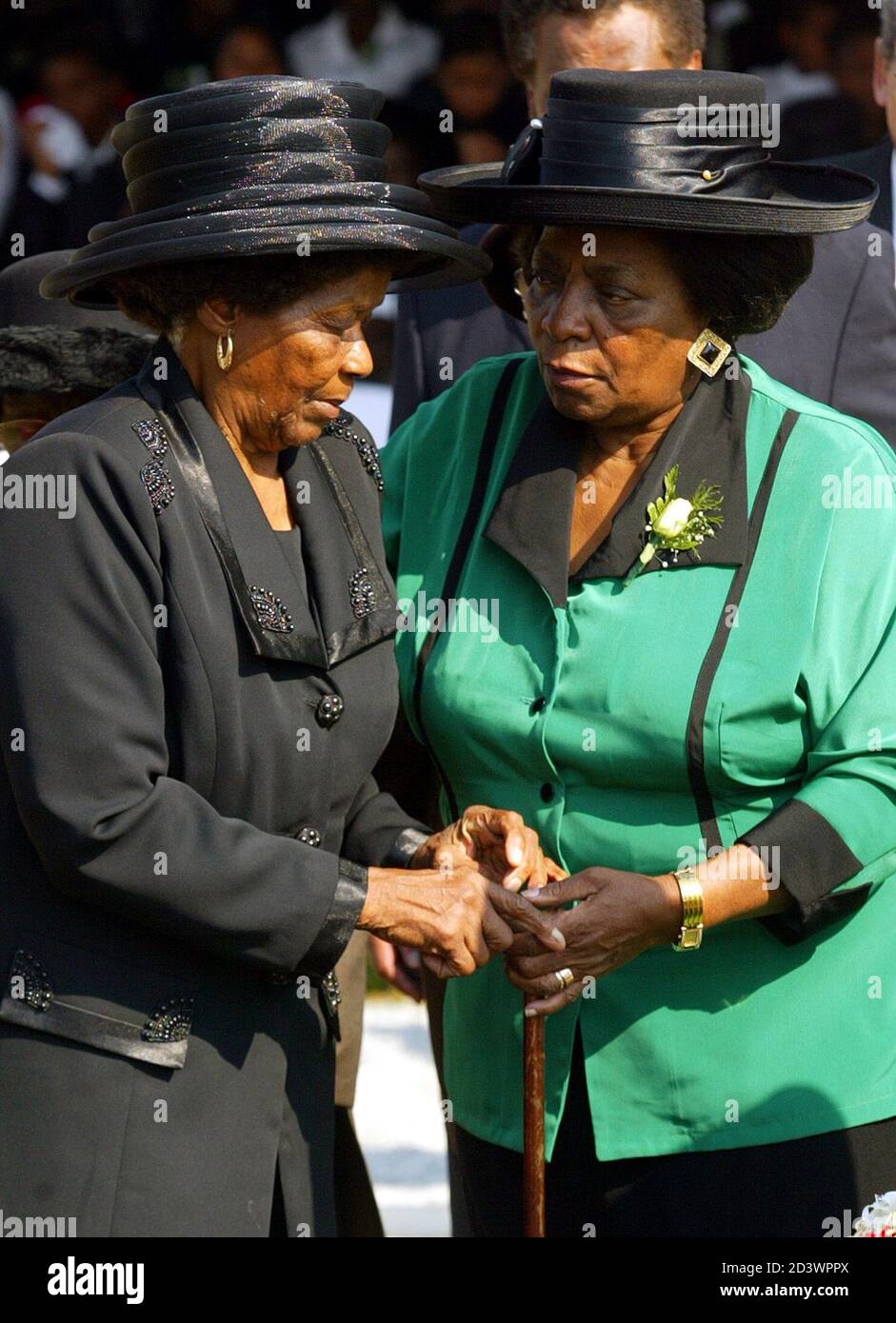 Albertina Sisulu (L) is comforted by Adelaide Tambo (R) as she turns away  from the grave of her husband, South African liberation hero Walter Sisulu,  May 17, 2003. Sisulu, hailed as the "
