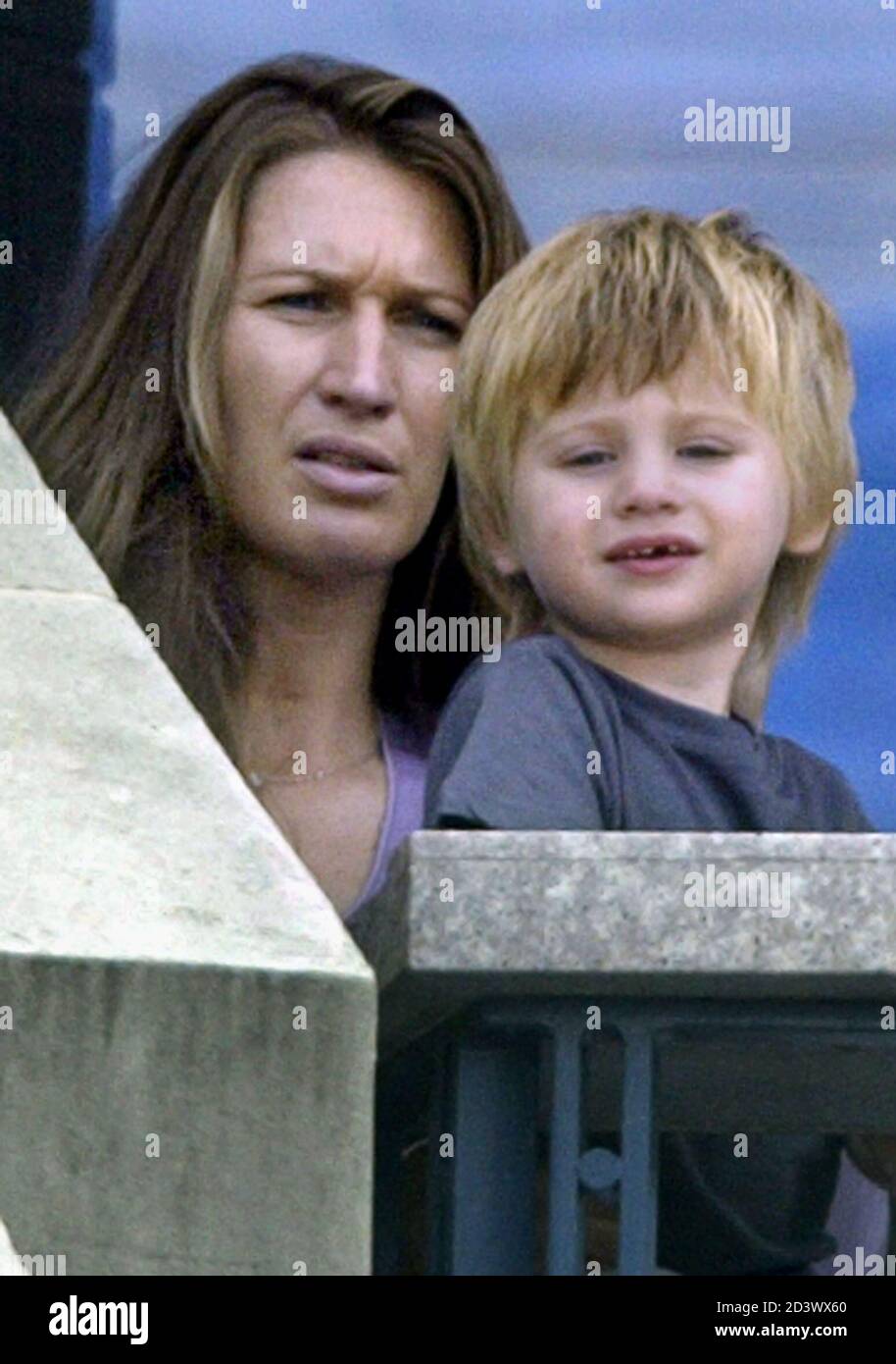 Steffi Graf (L) and her son Jaden Agassi watch Andre Agassi play Roger  Federer of Switzerland, in their quarter final match at the 2004 U.S. Open  in New York, September 9, 2004.