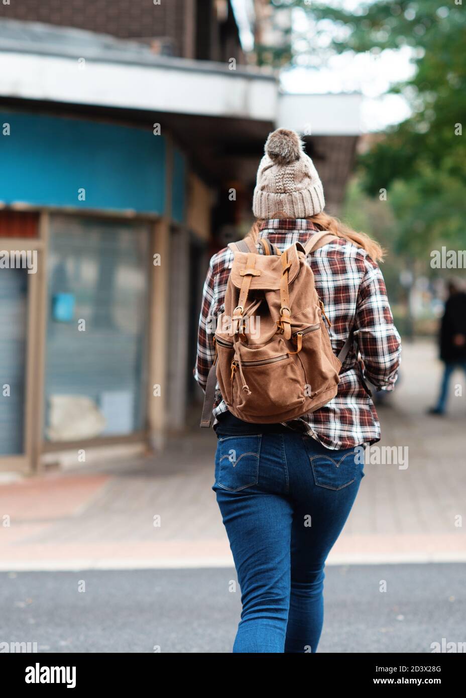 Woman walking across road hi-res stock photography and images - Alamy