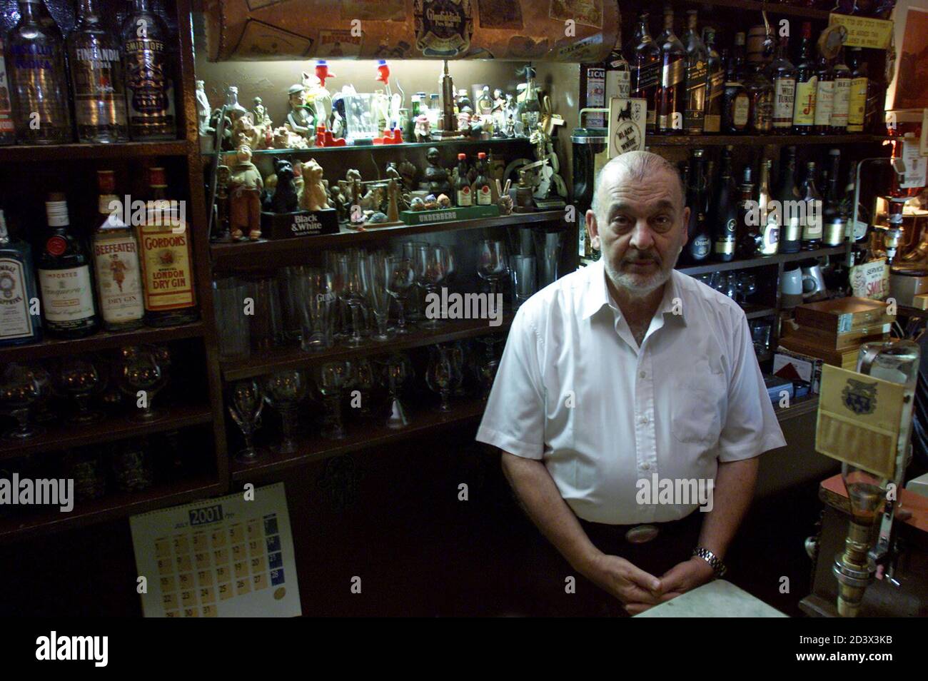 owner-of-finks-restaurant-mouli-azrieli-poses-behind-the-bar-in-jerusalem-any-foreign-correspondent-diplomat-or-spy-who-has-come-through-the-city-since-1932-will-surely-have-sat-at-one-of-the-restaurants-12-bar-stools-or-eaten-the-famous-goulash-at-one-of-its-six-tables-picture-taken-august-6-2001-reutersnatalie-behring-to-go-with-story-mideast-finks-by-michael-rose-nbgb-2D3X3KB.jpg