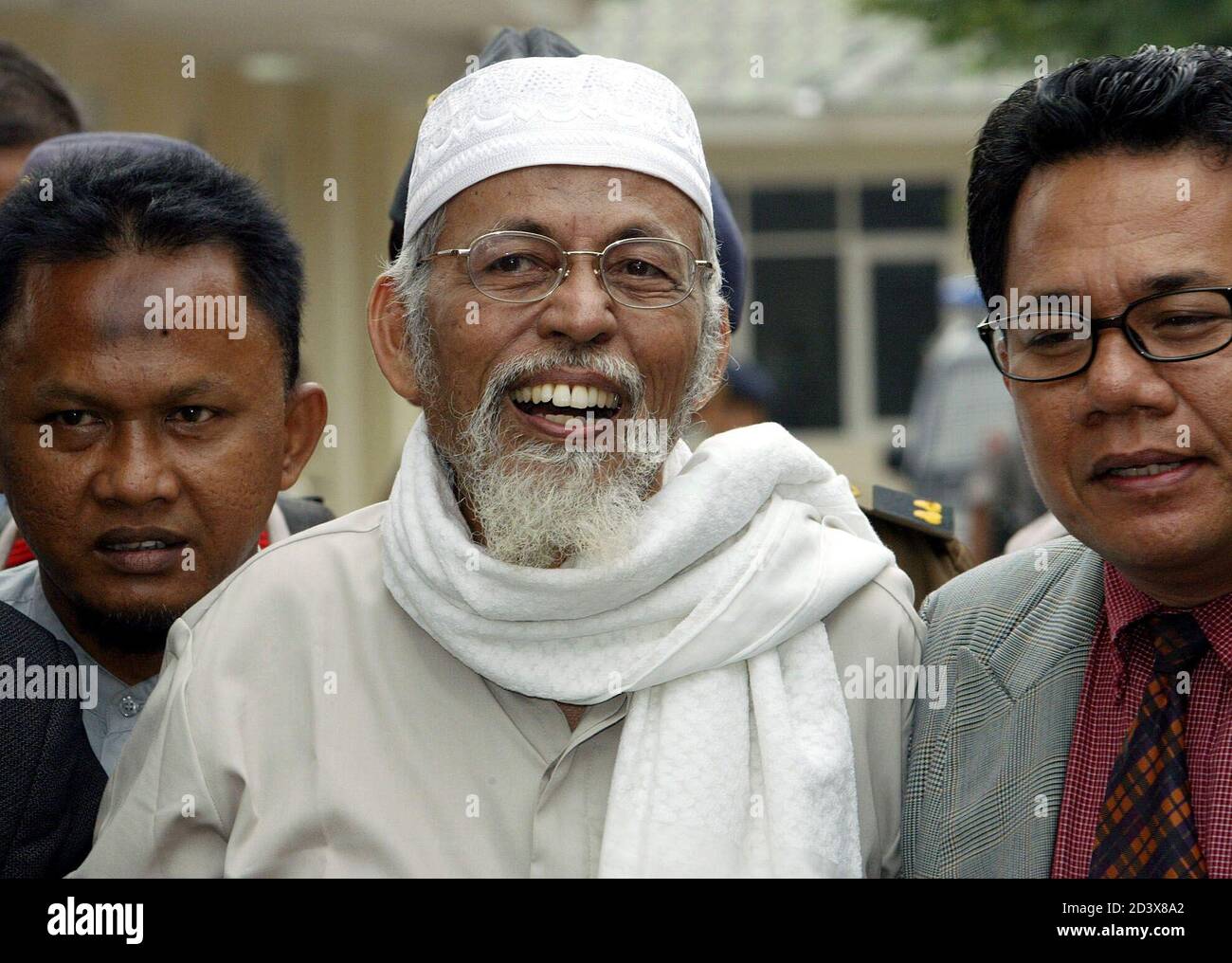 Indonesian Muslim Cleric Abu Bakar Bashir C Smiles As He Arrives At A Jakarta Court On April 30 2003 Bashir Suspected Of Leading A Violent Southeast Asian Islamic Network Stands On Trial