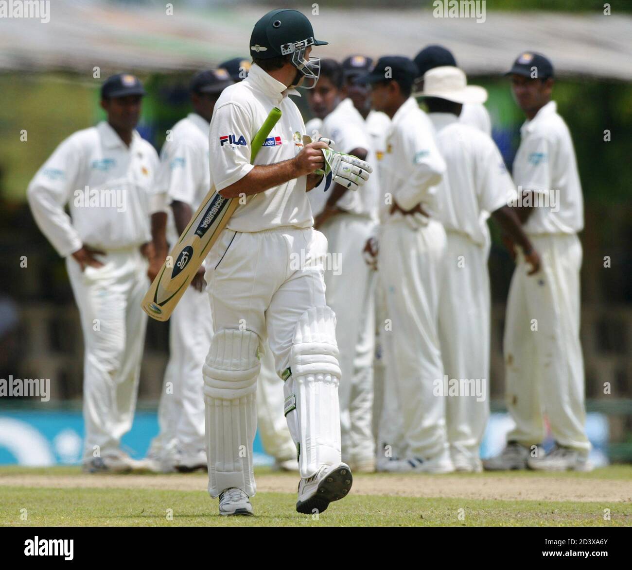 THE SRI LANKAN TEAM CELEBRATES AFTER DISMISSING AUSTRALIA'S CAPTAIN PONTING DURING THE FIRST DAY OF THE SECOND TEST IN KANDY.  The Sri Lankan team celebrates as Australia's captain Ricky Ponting (C) looks back at the umpire after being given out LBW for ten runs during the first day of the second test at Asgiriya Sportsground in Kandy March 16, 2004. Ponting elected to bat in the second test against Sri Lanka on Tuesday. REUTERS/David Gray Stock Photo