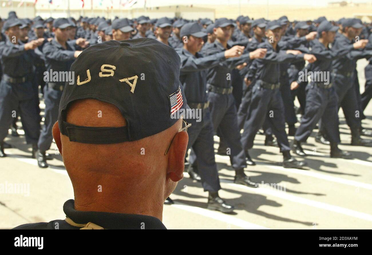 Iraqi police officers march in front of US officers during a graduation  ceremony after completing an eight-week training course at the Jordan International  Police Training Center near Amman May 13, 2004. About