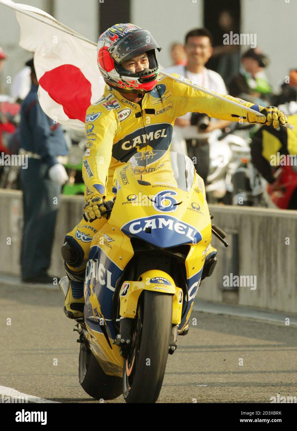 Motogp Rider Makoto Tamada Of Japan Waves His National Flag After Winning The Motorcycling Motogp Grand Prix Of Japan At Twin Ring Motegi In Motegi North Of Tokyo September 19 04 Tamada