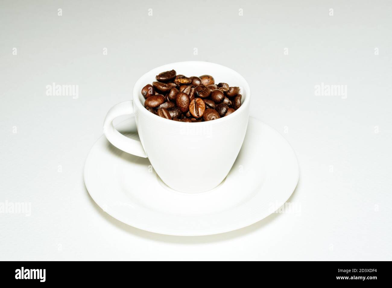 Coffee mug full of coffee beans Stock Photo