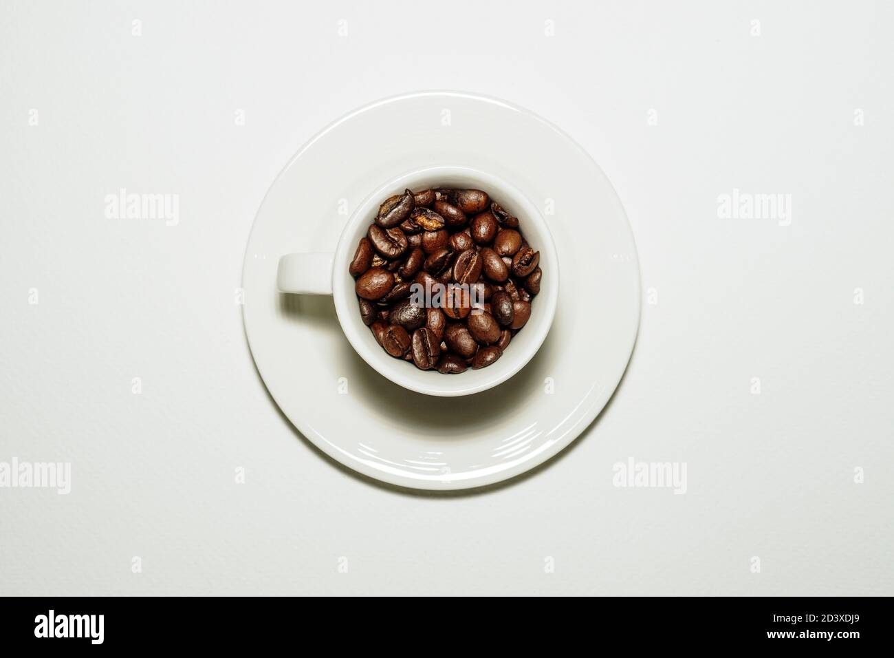 Coffee mug full of coffee beans Stock Photo