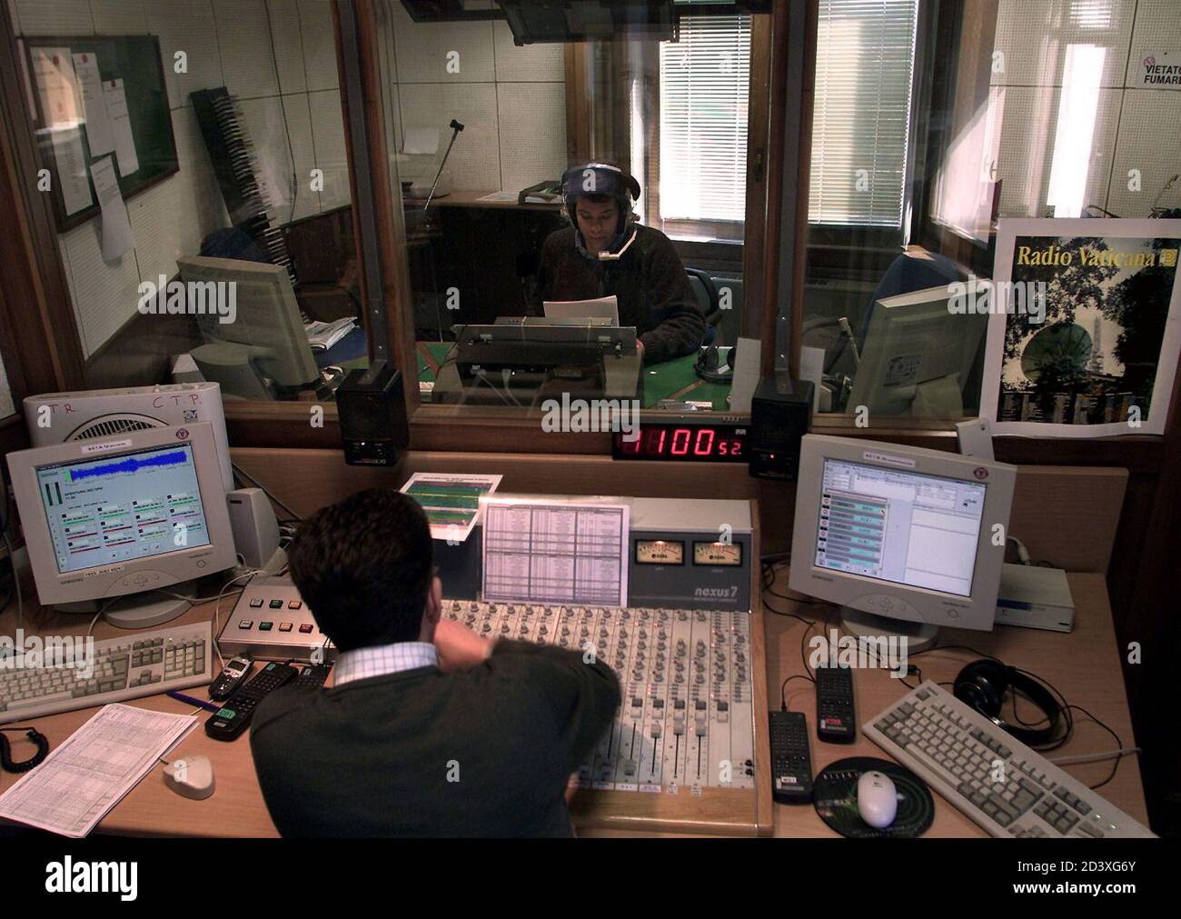 A Vatican Radio reporter speaks during a live programme in their English  language studios April 10, 2001. The Vatican, in an effort to stop the  Italian government from cutting off electricity to