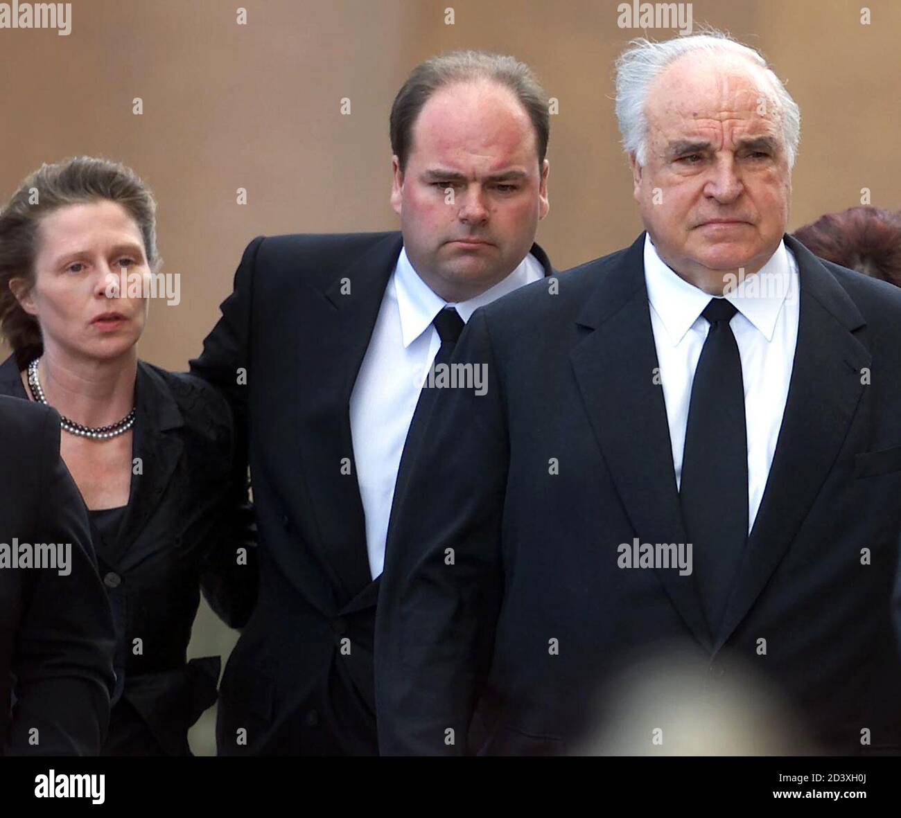 Former German Chancellor Helmut Kohl (R), his son Walter (C) and an unidentified woman arrive at the Speyer cathedral prior to a memorial service for Hannelore Kohl July 11, 2001. Hannelore Kohl, who was 68, took her own life last week after a long illness. She had suffered from a rare allergy to light that forced her to stay in darkened rooms indoors for the last 15 months of her life.  JOH/FMS Stock Photo