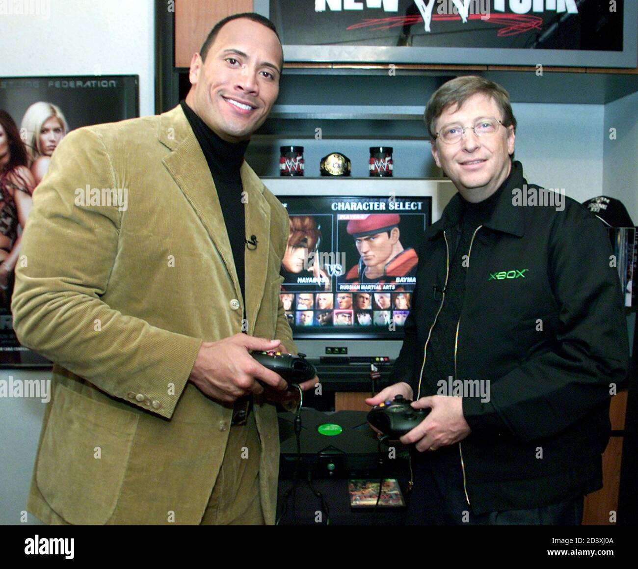 Bill Gates, (R) Chairman and Chief Software Architect of Microsoft plays an  Xbox game with World Wrestling Federation star Duane "The Rock" Johnson in  New York, November 14, 2001. Johnson took part
