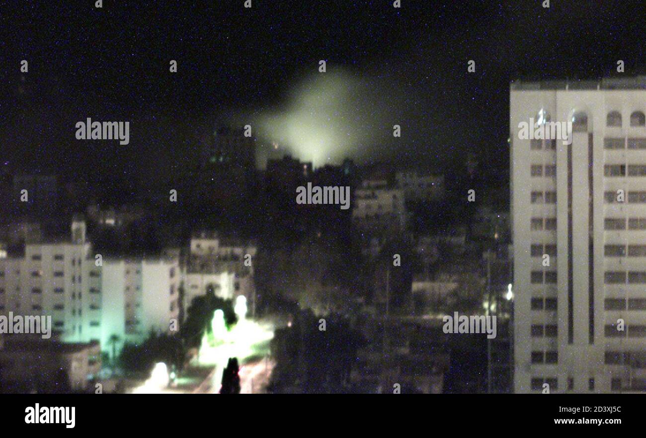 Smoke rises over Palestinian police headquarters after it was hit by misiles from Israeli warplanes in the Gaza Strip December 13, 2001. Israeli warplanes bombed Palestinian security installations in the Gaza Strip and the West Bank on Wednesday, hours after 10 Israelis were killed in a West Bank bus ambush and a double suicide bombing in Gaza. REUTERS/Suhaib Salem REUTERS Stock Photo
