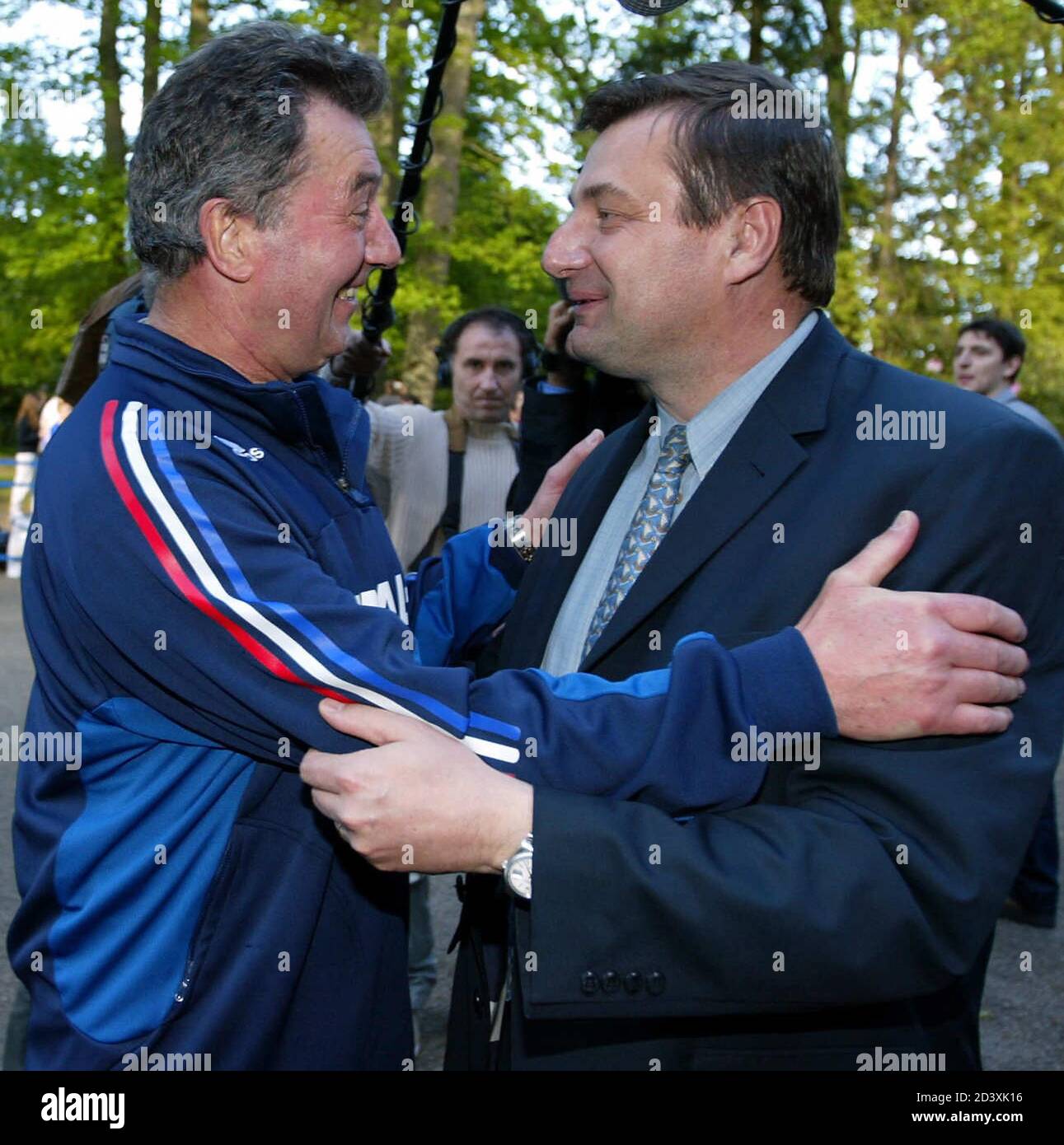 France World Cup team soccer coach Roger Lemerre (L) greets new French Sports Minister Jean-Francois Lamour (R) at their training camp in Clairefontaine, near Paris, May 14, 2002. France prepares for their last friendly soccer match against Belgium ahead of the World Cup finals. REUTERS/Patrick Hertzog/Pool  JES Stock Photo