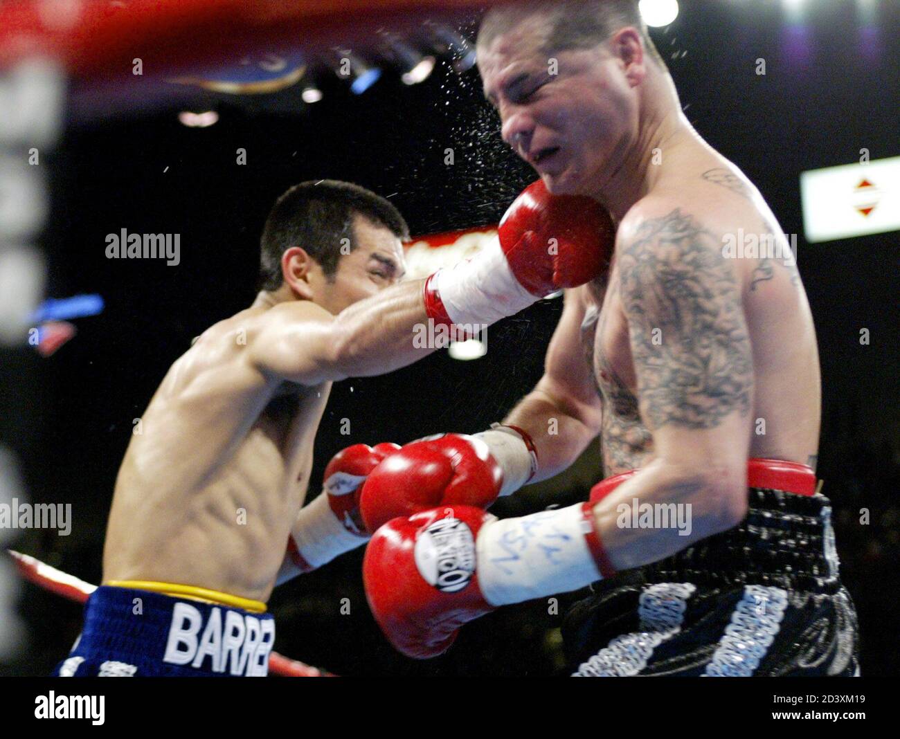 Featherweight boxer Marco Antonio Barrera (L) of Iztacalo, Mexico, lands a right on Johnny Tapia of Albuquerque, New Mexico, during the fourth round of a 12-round fight at the MGM Grand Garden Arena Las Vegas, Nevada, November 2, 2002.  Barrera won the bout by unanimous decision. Stock Photo
