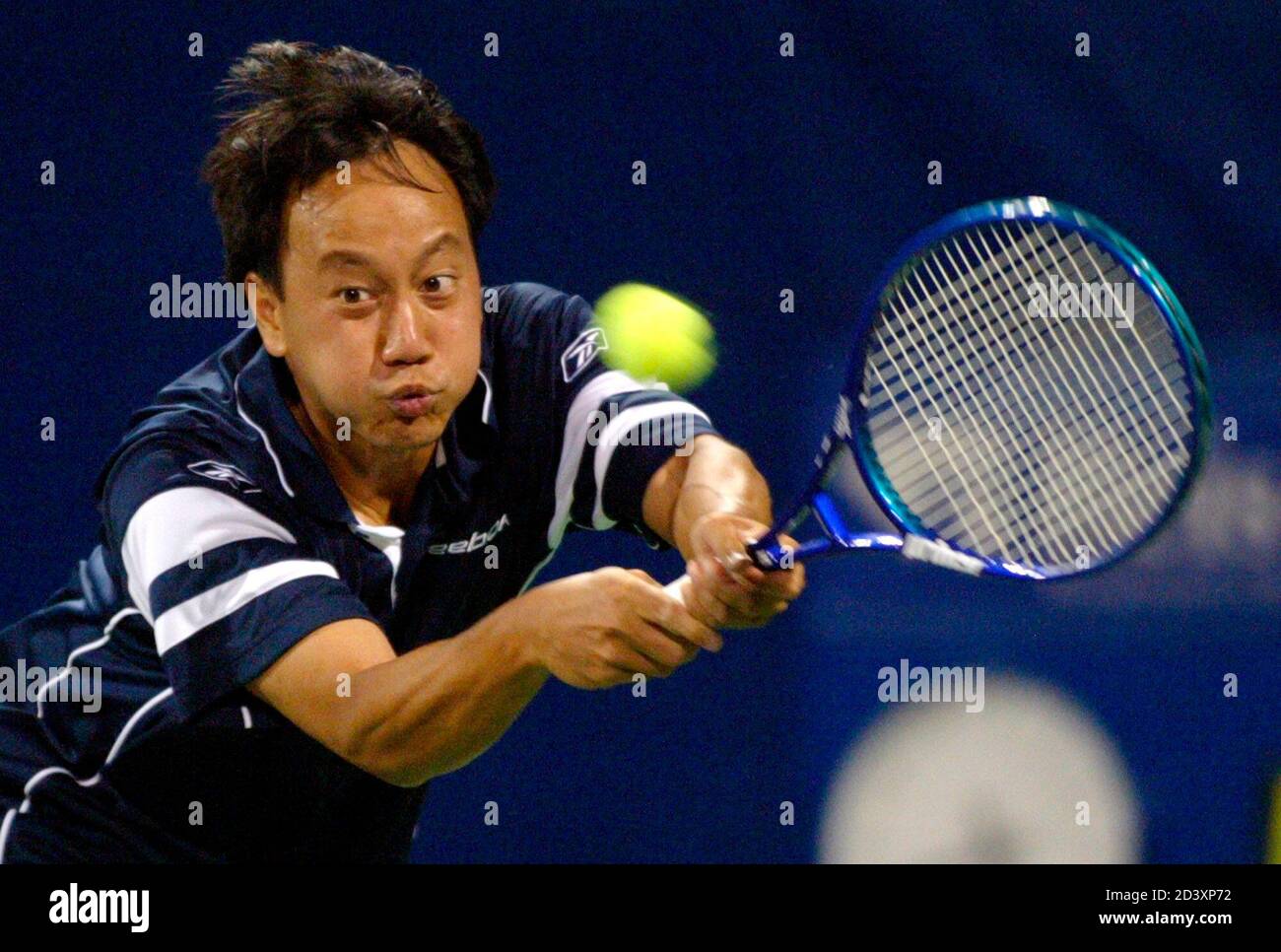 Michael Chang of the United States reaches out to return serve to Eric  Taino of the United States during the RCA Championships tennis tournament  in Indianapolis July 21, 2003. It is Chang's