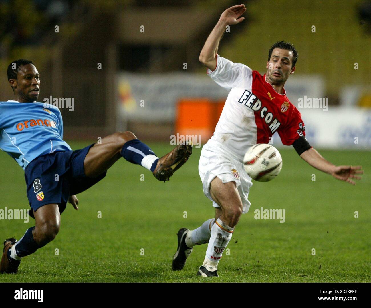Monaco S Ludovic Giuly R Fights For Control Of The Ball With Sydou Keita L Of Lens During Their French Ligue 1 Soccer Match In Monaco November 22 2003 Stock Photo Alamy