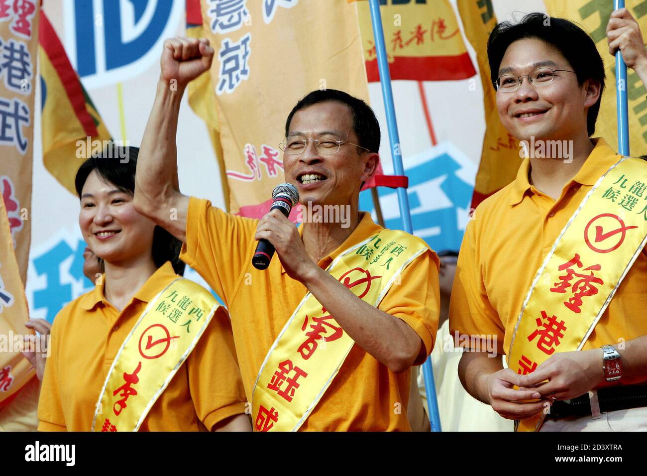 Jasper Tsang Yok-sing (C), former chairman of Democratic Alliance for Betterment of Hong Kong (DAB) party, Hong Kong's biggest pro-China party, and other party members waves during during their kicked off campaign for September's legislative elections in Hong Kong July 25, 2004. [Hong Kong's biggest pro-China party said on Friday it will push for universal suffrage in 2012 as campaigning intensifies for September's hotly contested legislative elections.] Stock Photo