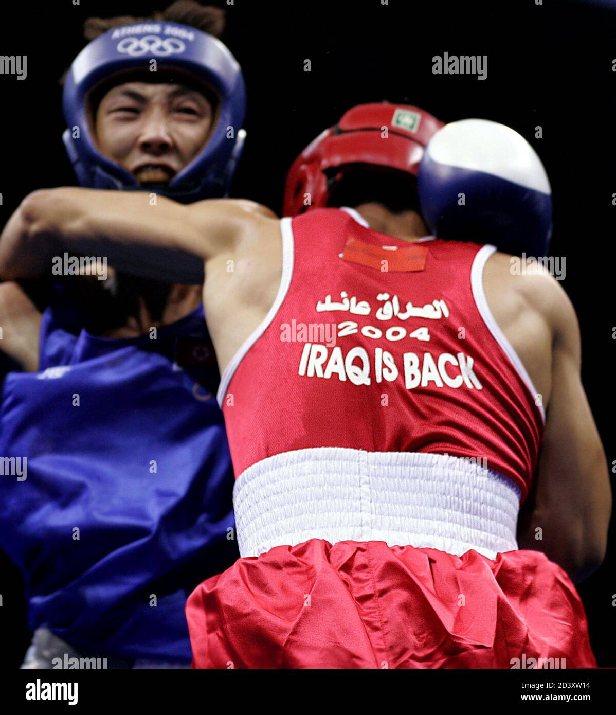 Iraqi boxer Najah Ali holds Kwak Hyok Ju of North Korea during their round of 32 bout at the Athens 2004 Olympic Summer Games boxing tournament August 18, 2004. Ali won the fight. Stock Photo