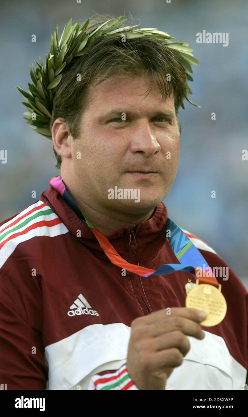 Hungary's Adrian Annus holds his gold medal for men's hammer throw at the  medals ceremony at Olympic Stadium at the 2004 Olympic Games in Athens,  Greece August 23, 2004. REUTERS/Mike Blake JSK