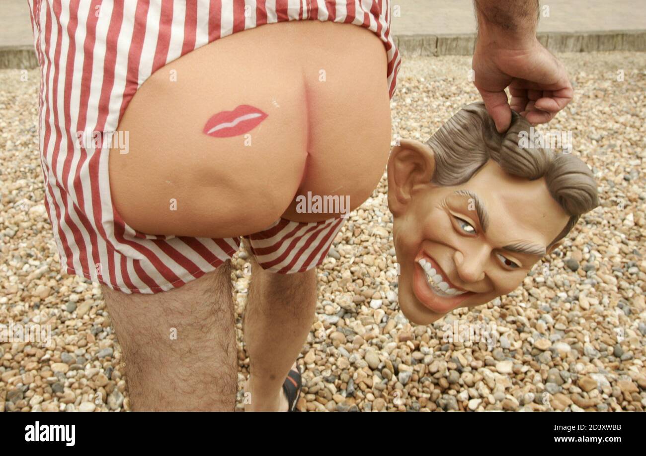 A pensioner carrying a 'Prime Minister Tony Blair' mask and wearing plastic buttocks takes part in a demonstration on the sea front outside the venue for the Labour Party conference in Brighton September 29, 2004. The pensioners are protesting over losing their pensions through company insolvency. Stock Photo