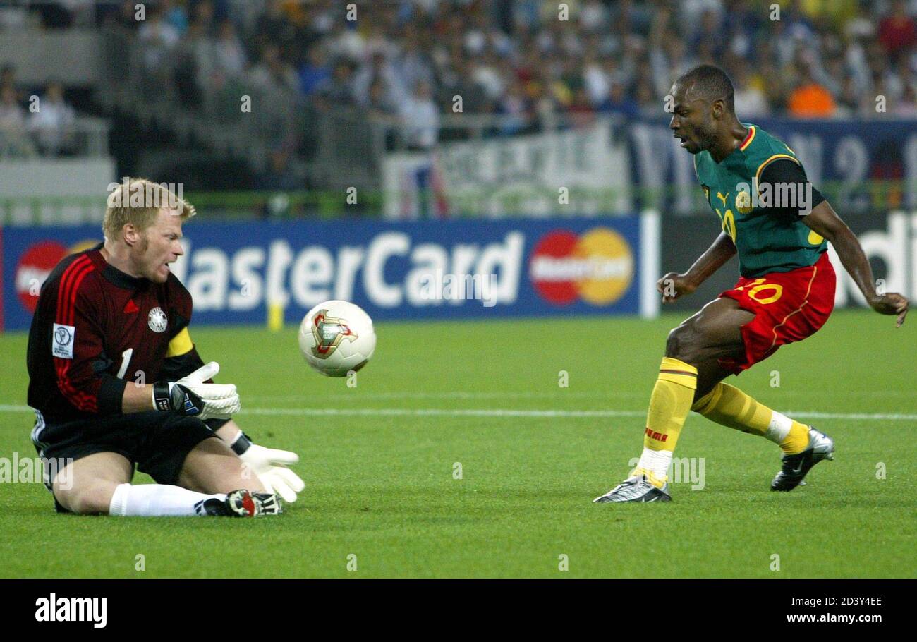 Germany's goalkeeper Oliver Kahn (L) saves the ball from Cameroon's Salomon  Olembe during their Group E match at the World Cup Finals in Shizuoka June  11, 2002. Group E includes [ Ireland,