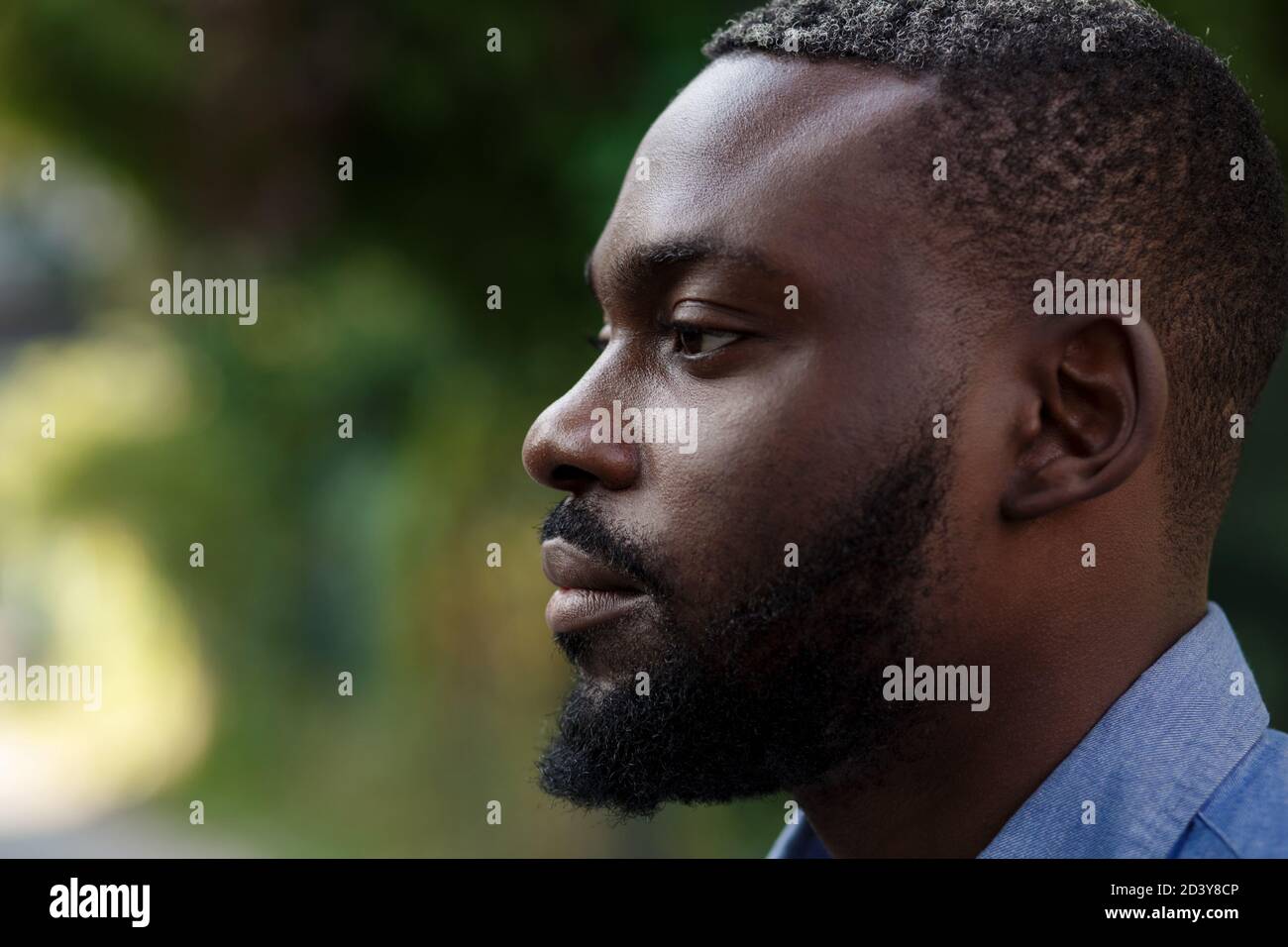 Close up portrait of serious African American man with open eyes ...