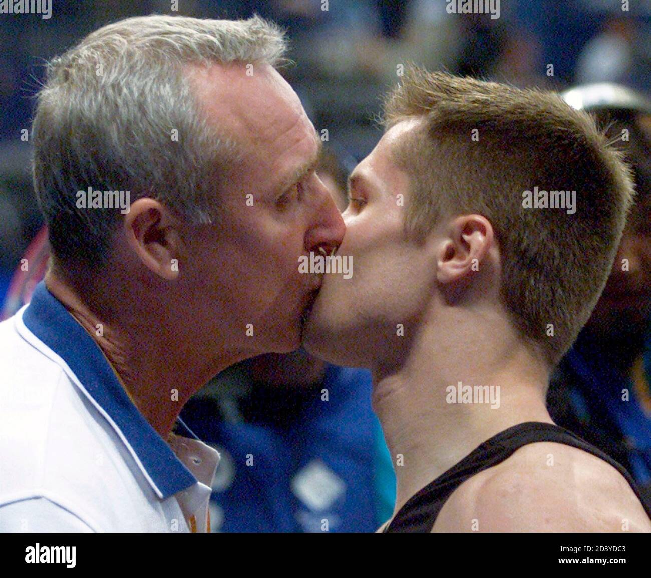 RUSSIA'S ALEXEI NEMOV RECEIVES A CONGRATULATORY KISS FROM COACH LEONID  ARKAEV AT THE SYDNEY 2000 OLYMPIC GAMES. Russia's Alexei Nemov (R) receives  a congratulatory kiss from head coach of Russia's gymnastic team