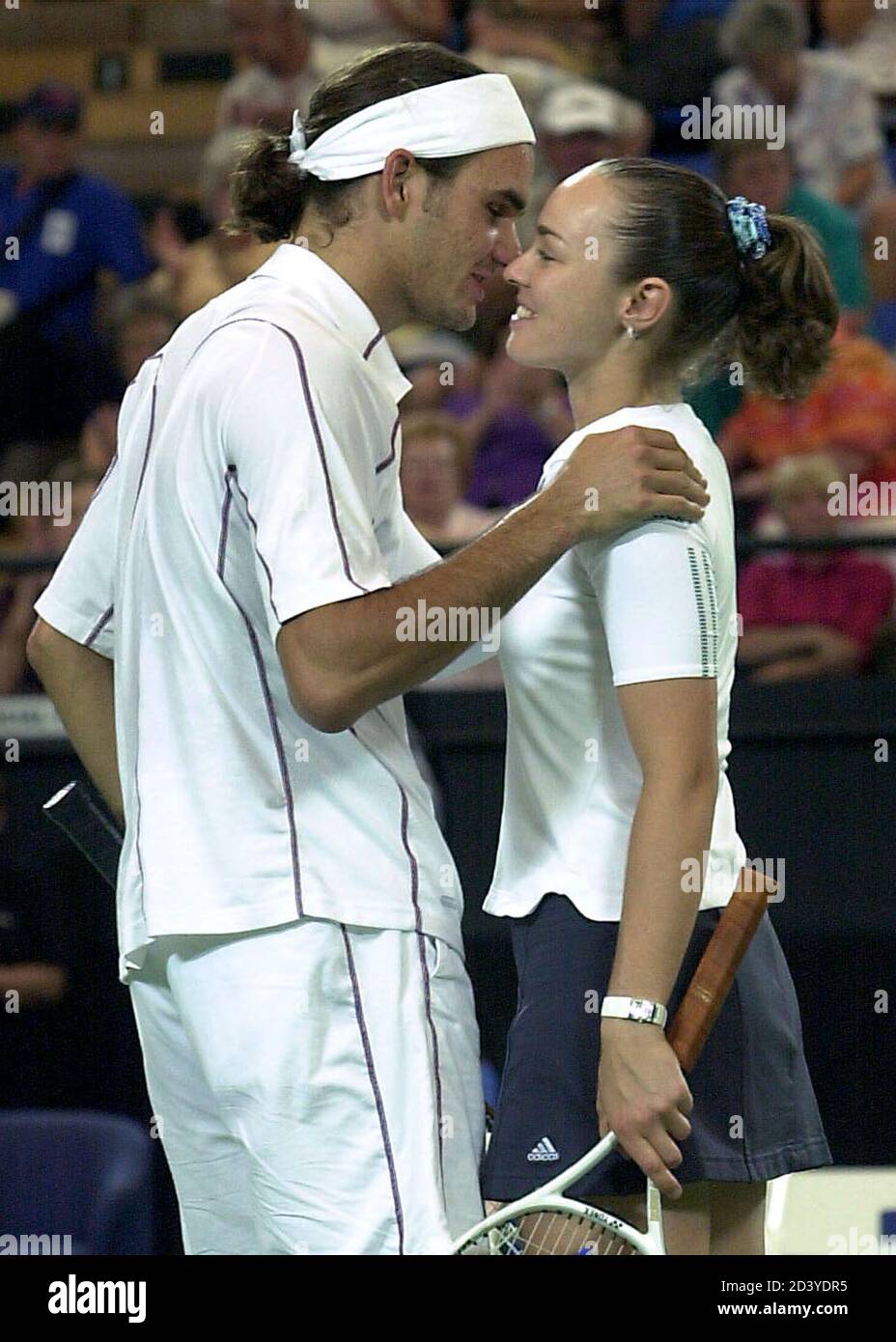 Switzerland's Roger Federer kisses compatriot Martina Hingis after  defeating South Africa's Wayne Ferreira and Amanda Coetzer (not pictured)  during the doubles rubber of the Hopman Cup at the Burswood Dome in Perth,