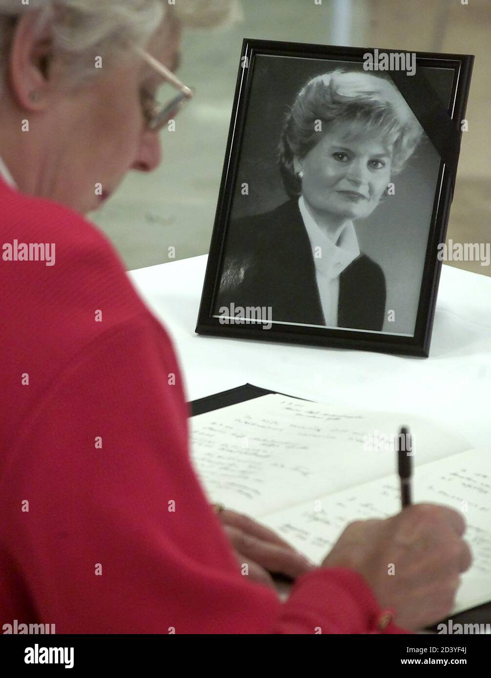 An unidentified woman signs the condolence book for Hannelore Kohl, wife of former German Chancellor Helmut Kohl inside the conservative Christian Democratic Union party headquarters' in Berlin July 8, 2001.  FAB Stock Photo