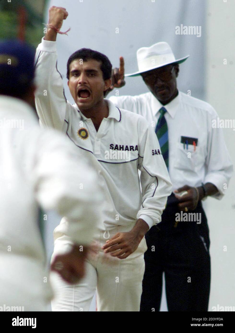 INDIAN SKIPPER SOURAV GANGULY CELEBRATES SRI LANKAN WICKET OF SURESH PERERA DURING THE SECOND TEST MATCH IN KANDY SRILANKA.   Indian skipper Sourav Ganguly (C) celebrates the wicket of Sri Lankan batsman Suresh Perera as umpire Steve Bucknor (R) signals his decision during the first day of their second test in Kandy, Sri Lanka August 22, 2001. Stock Photo