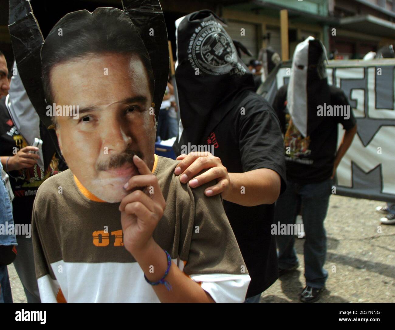 A STUDENT WEARS A MASK OF EX-GUATEMALAN PRESIDENT ALFONSO PORTILLO DURING THE ANNUAL 'HUELGA DE LOS DOLORES' PARADE.  A student from the University of San Carlos wears a mask of ex-Guatemalan president Alfonso Portillo during the annual 'Huelga de los Dolores' parade April 2, 2004 in Guatemala City. The event, a tradition for 106 years, is now used by the students as a chance to air their grievances against the government. REUTERS/Daniel LeClair Stock Photo