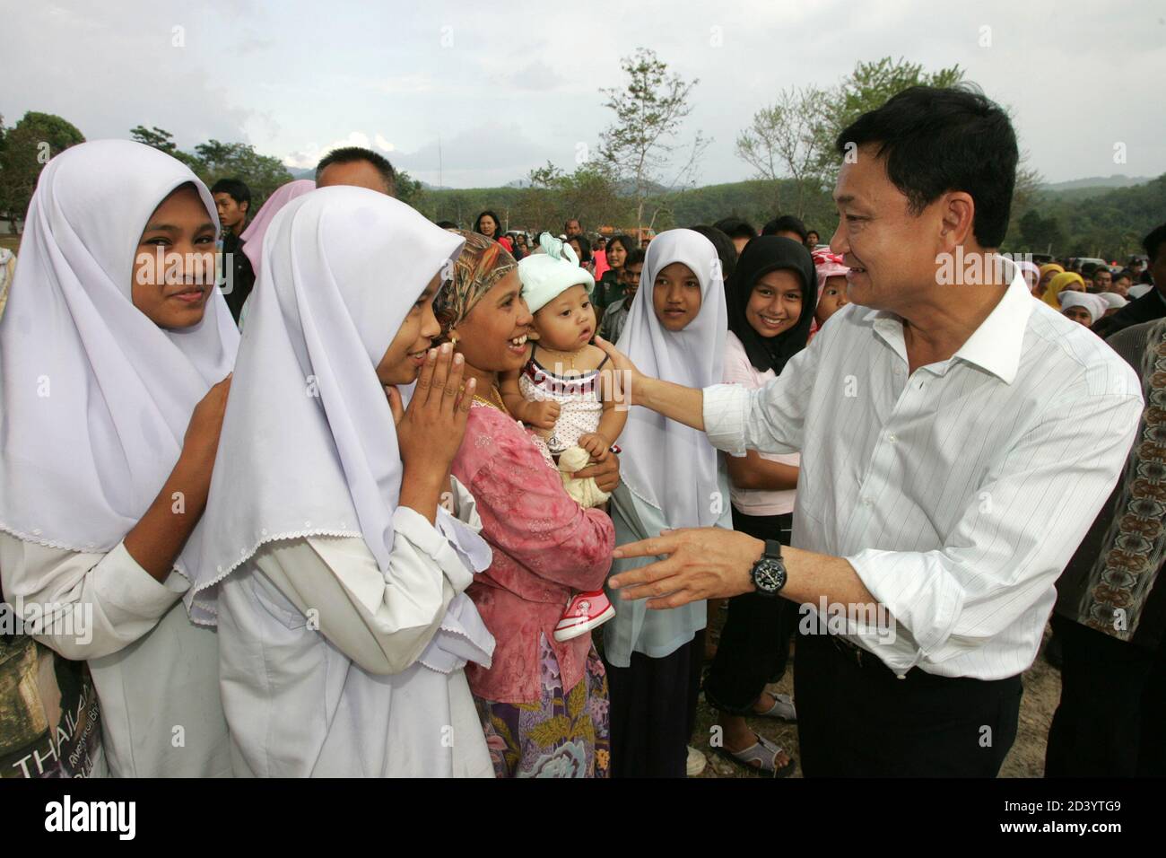 Thai Prime Minister Thaksin Shinawatra meets villagers in Yala province, 1,200 km (750 miles) south of Bangkok, on February 16, 2005. Thaksin arrived in the largely Muslim south on Wednesday with a stern message for villagers tempted to help separatist militants. REUTERS/Sukree Sukplang  SS/SA Stock Photo