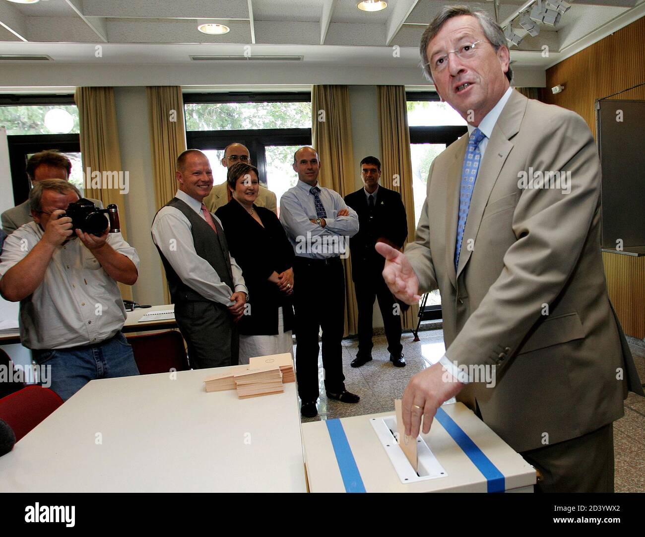 Luxembourg Prime Minister Jean-Claude Juncker (R) gestures as he casts his  vote during a referendum on the European Union constitution at the Capellen  Cultural Center in Luxembourg July 10, 2005. Luxemburgers went