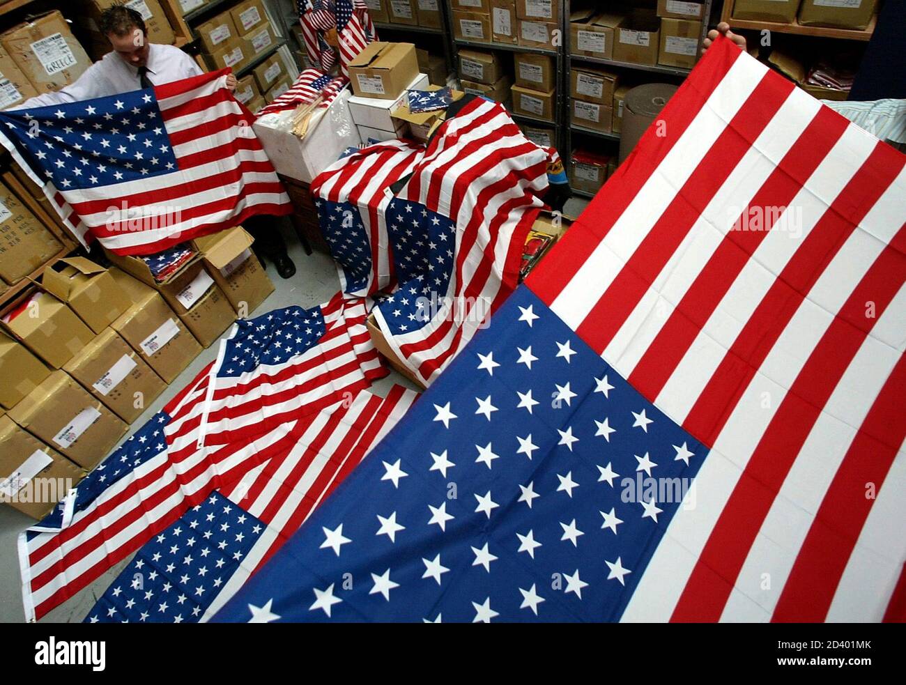 Alex Petrovic folds U.S. flags after quality checks at the Australian  distribution company 'AJ FLags' in Sydney September 9, 2002. More than  100,000 U.S. flags were sold by AJ Flags in just