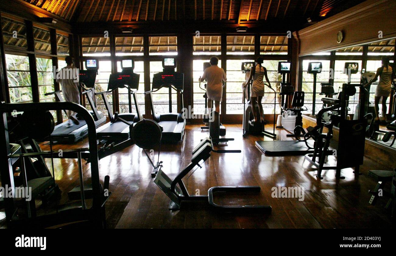 Guests work out in the fitness room of the spa at the Four Seasons Hotel on  Bali, August 13, 2003. With room rates from $575 to $3500 per night, the Four  Seasons