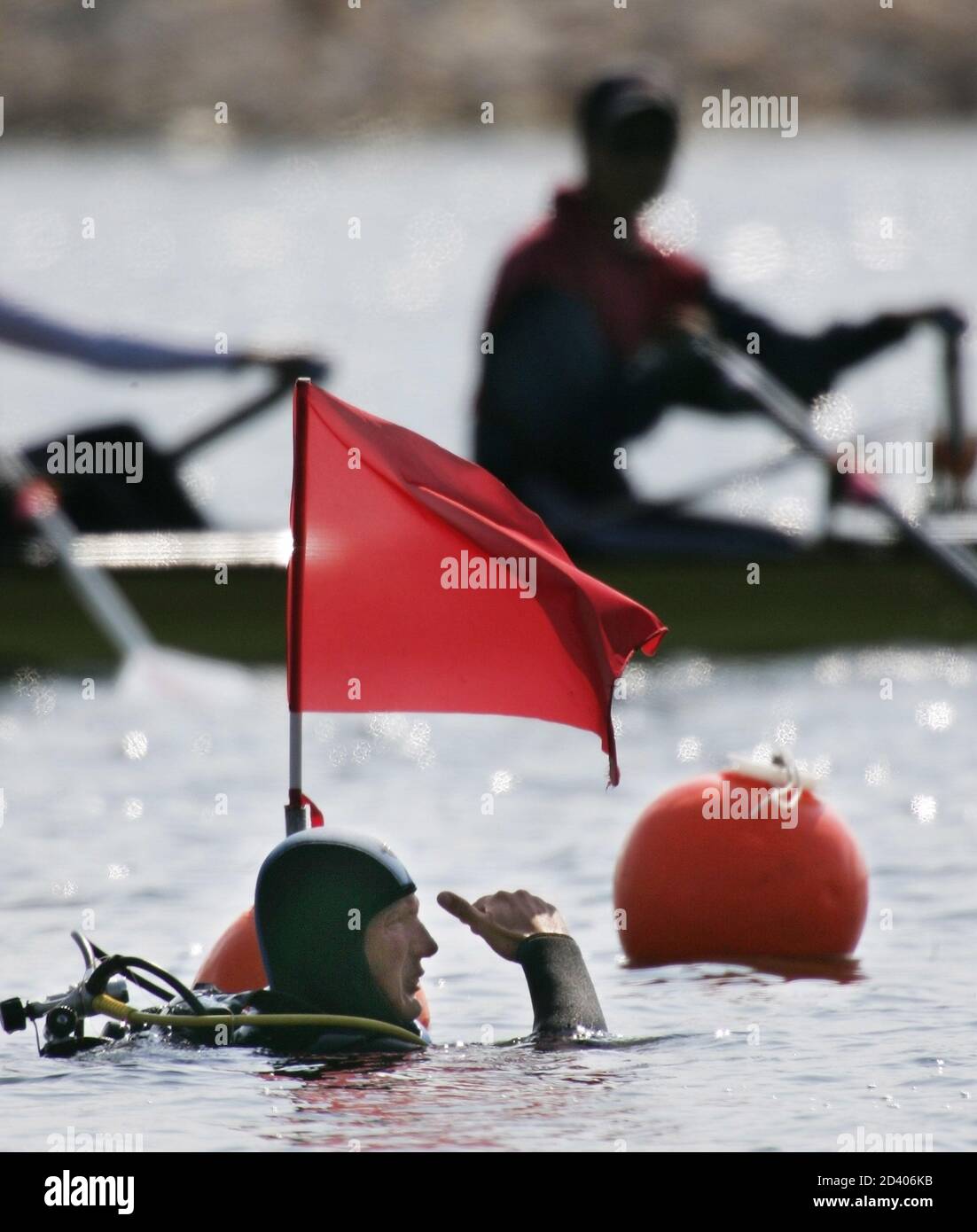 A frogman keeps watch as rowers go by while they were training at the