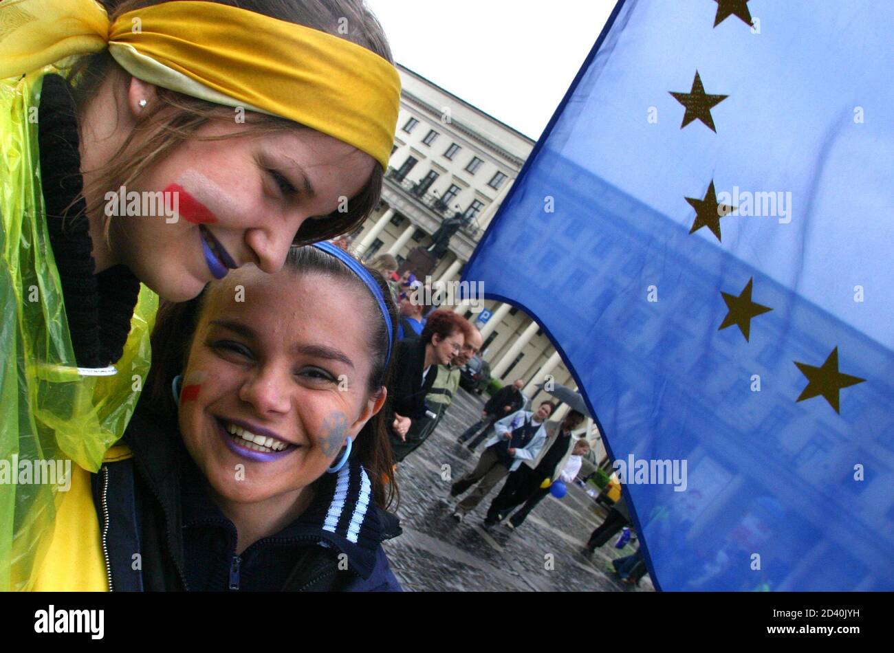 TWO POLISH GIRLS, WHOSE FACES DISPLAYED THE COLOURS OF POLAND AND THE EUROPEAN UNION, SMILE