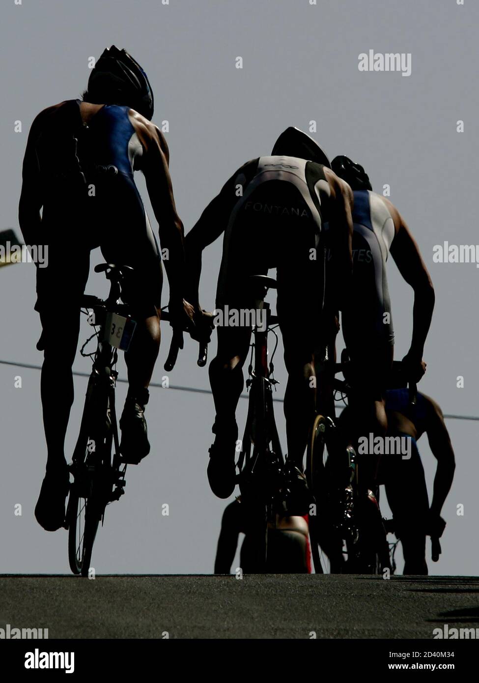 Competitors ride bikes as they climb a hill during the men's triathlon event at the Athens 2004 Olympic Games, August 26, 2004. REUTERS/Kim Kyung-Hoon  KKH Stock Photo