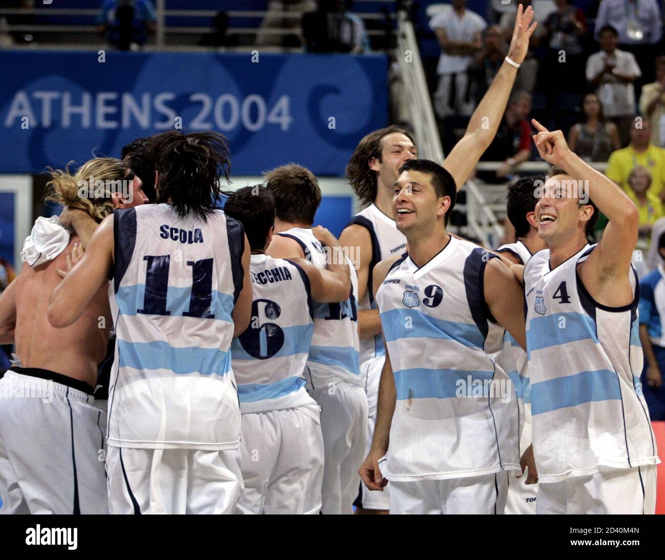 Argentina basketball players Gabriel Fernandez (R) and Juan Ignacio Sanchez  (2ndR) celebrate with team mates after defeating the U.S. in their men's  basketball semi-final match at the Athens 2004 Olympic Games, August