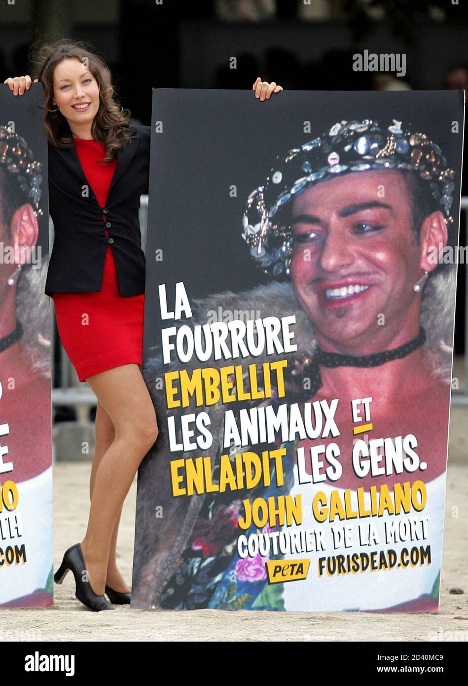 An activist of PETA association (People for the Ethical Treatment of Animals)  demonstrate outside British designer John Galliano's Spring-Summer 2005  ready-to-wear fashion shown in Paris, October 5, 2004. Posters read 