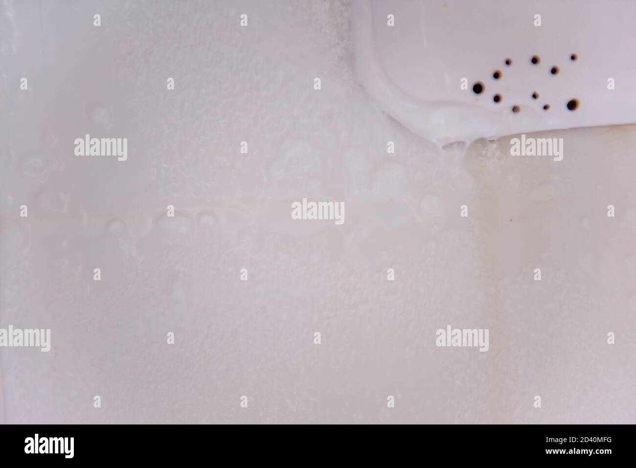 Dirty, unwashed and frosty refrigerator. Violation and non-compliance with sanitary and epidemiological standards, irresponsible attitude Stock Photo