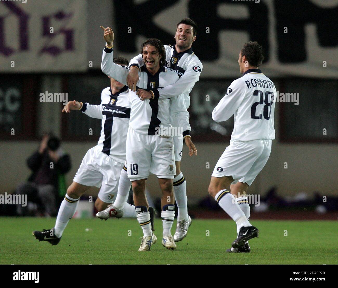 Parma celebrates a goal against Austria Vienna during their UEFA Cup quarter-final first leg soccer match at the Happel Stadium.  Paolo Cannavaro (R, 28), Andrea Pisanu (L, 19) and Cesare Bovo (C, top) of Italy's Parma celebrate a goal against Austria Vienna during their UEFA Cup quarter-final first leg soccer match at the Happel Stadium, Vienna, April 7, 2005. REUTERS/Robert Zolles Stock Photo