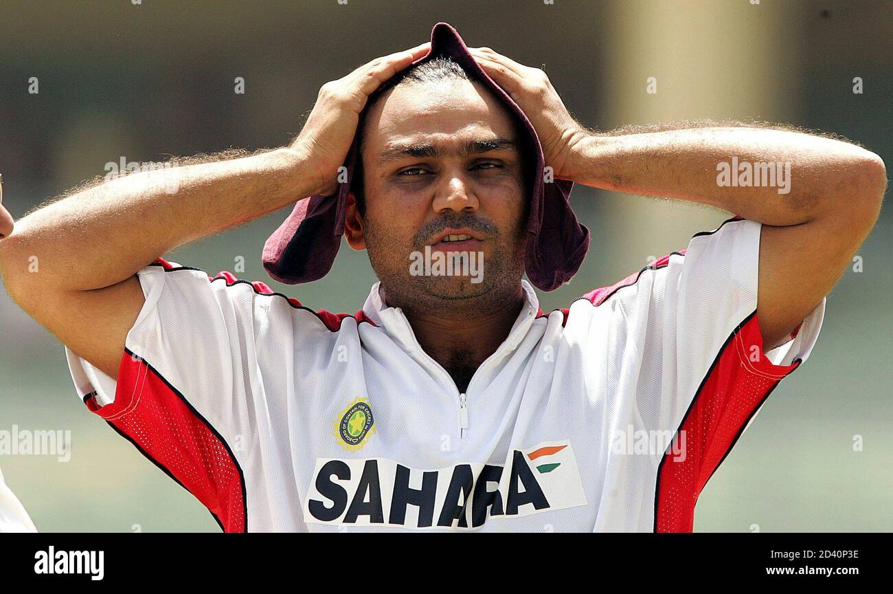India's batsman Virender Sehwag covers his headduring the practice session  on the eve of the fifth one-dayer in India. India's batsman Virender Sehwag  covers his head to get relief from the scorching