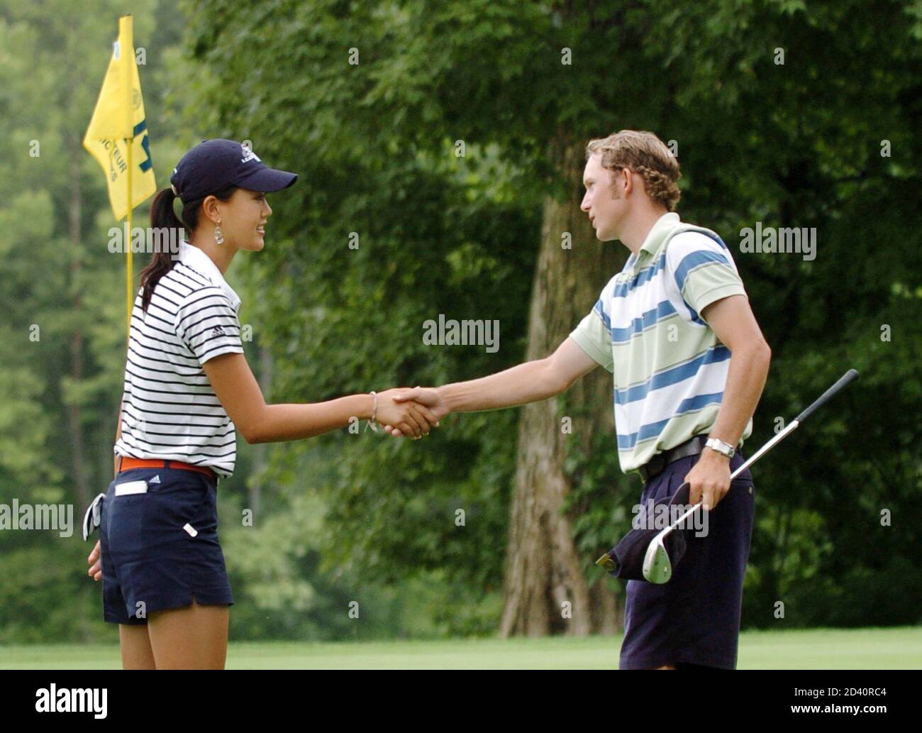 Michelle Wie shakes hands with Clay Ogden after Ogden defeated her in their quarter-final round in Lebanon, Ohio.  Michelle Wie (L) of the U.S. shakes hands with compatriot Clay Ogden after Ogden defeated her 5 and 4 on the 14th green in their quarter-final round of match play in the 2005 United States Amateur Public Links Championship at Shaker Run Golf Club in Lebanon, Ohio, July 15, 2005. REUTERS/John Sommers II Stock Photo