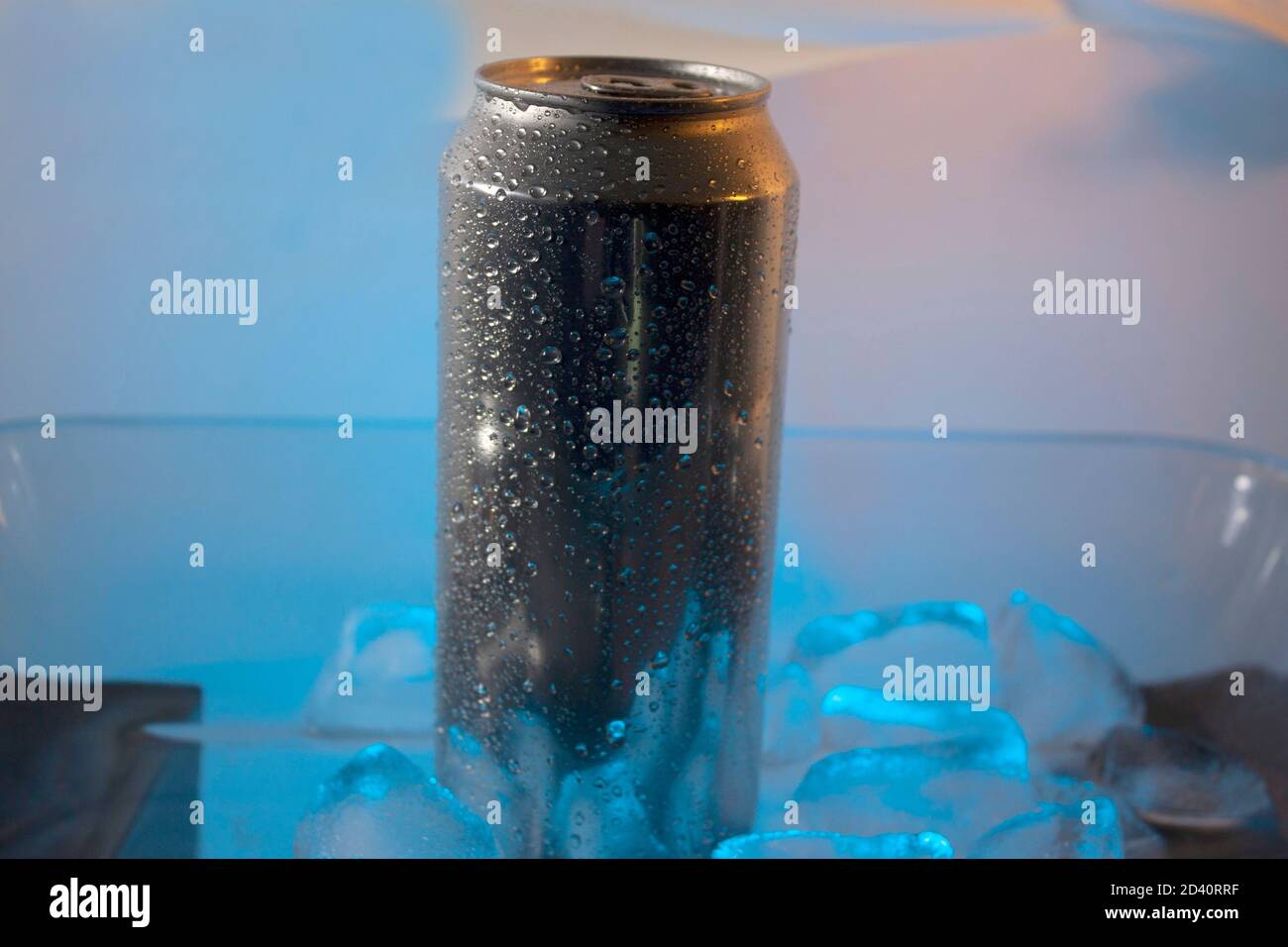Silver can surrounded by icy droplets standing inside blue ice in Mexico with no people in the scene Stock Photo
